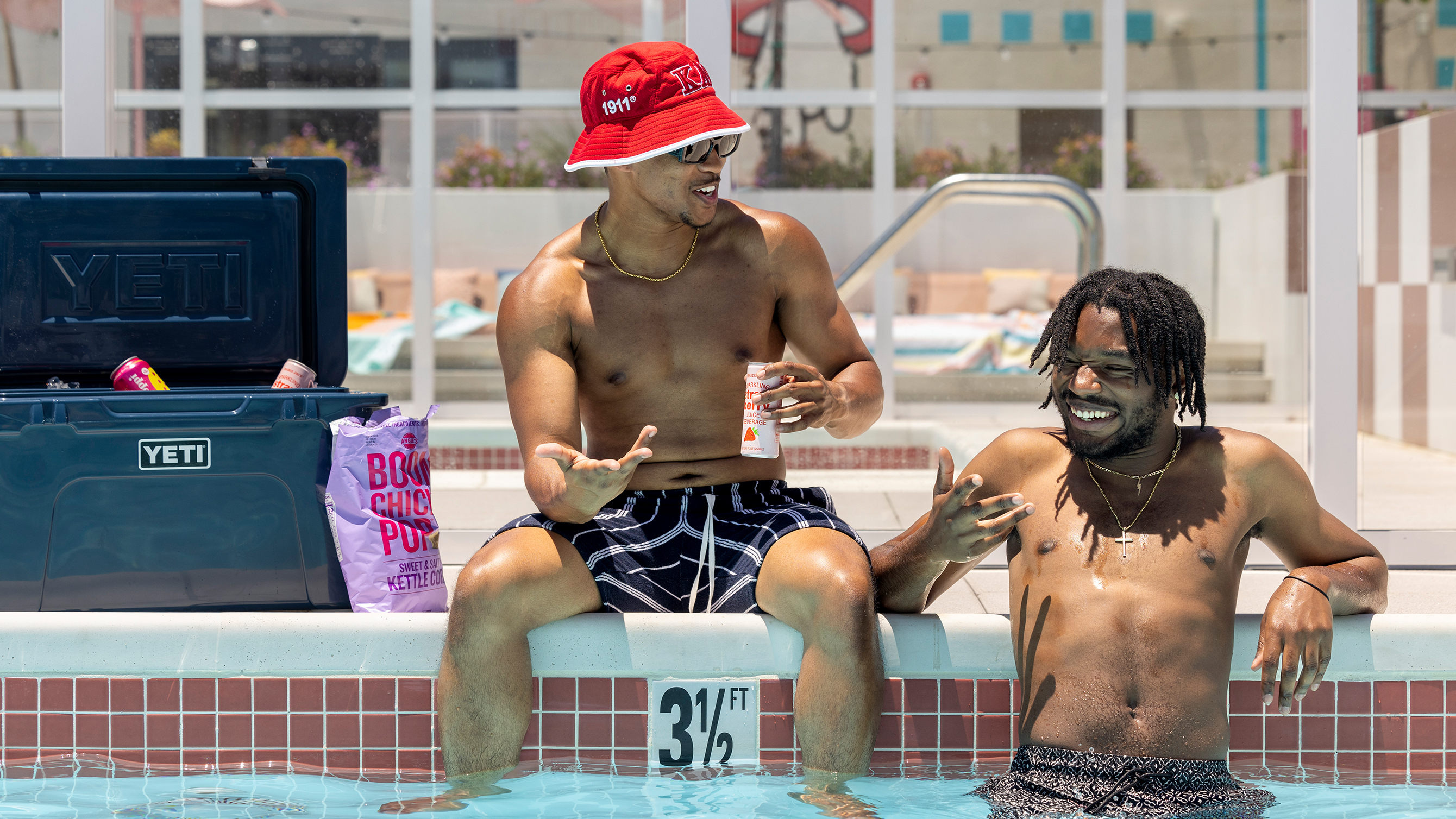 Friends talking while in a swimming pool