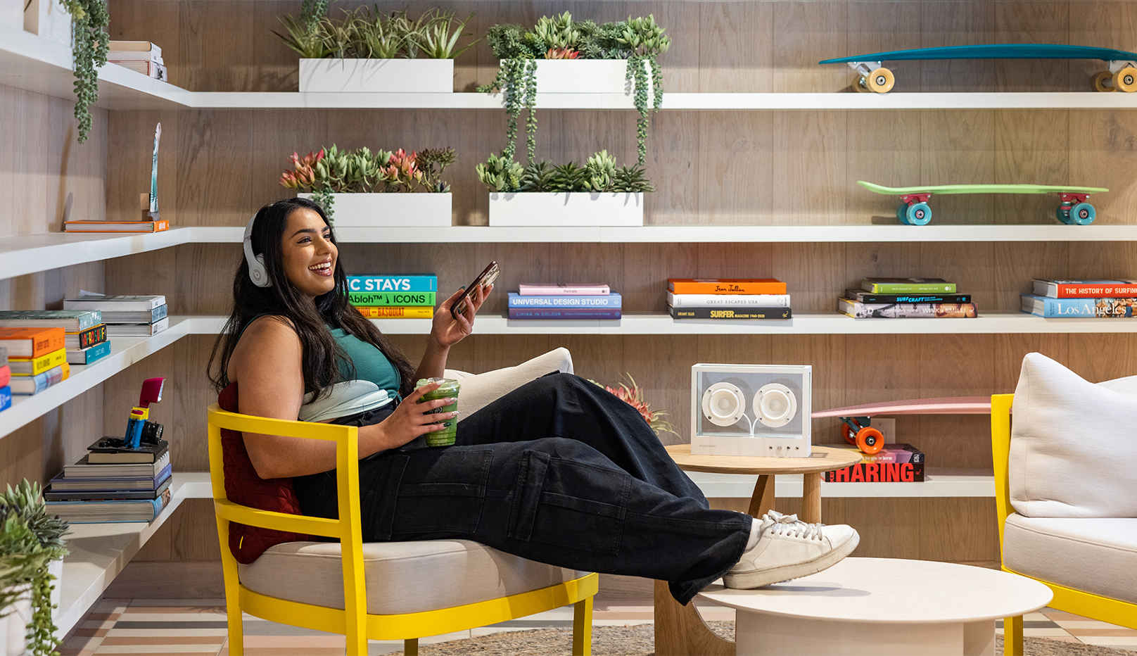 A woman sitting and wearing headphones